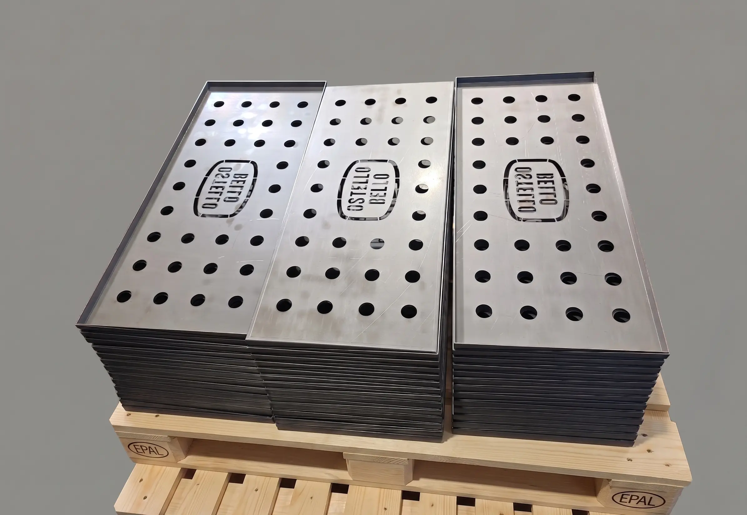 Square pieces made from ultra-thick sheet metal, laser engraved with the DPEMME logo