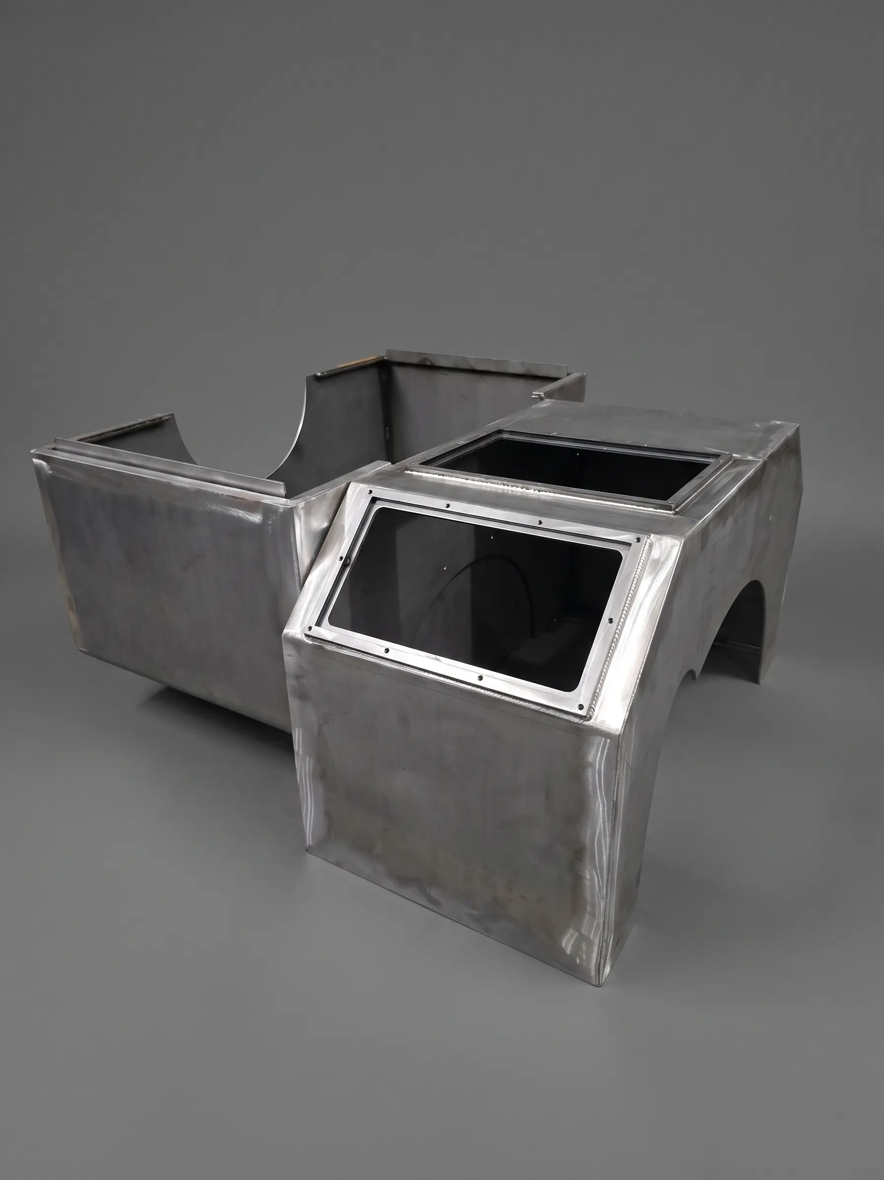Large angular welded iron protective casing or enclosure, in raw finish
